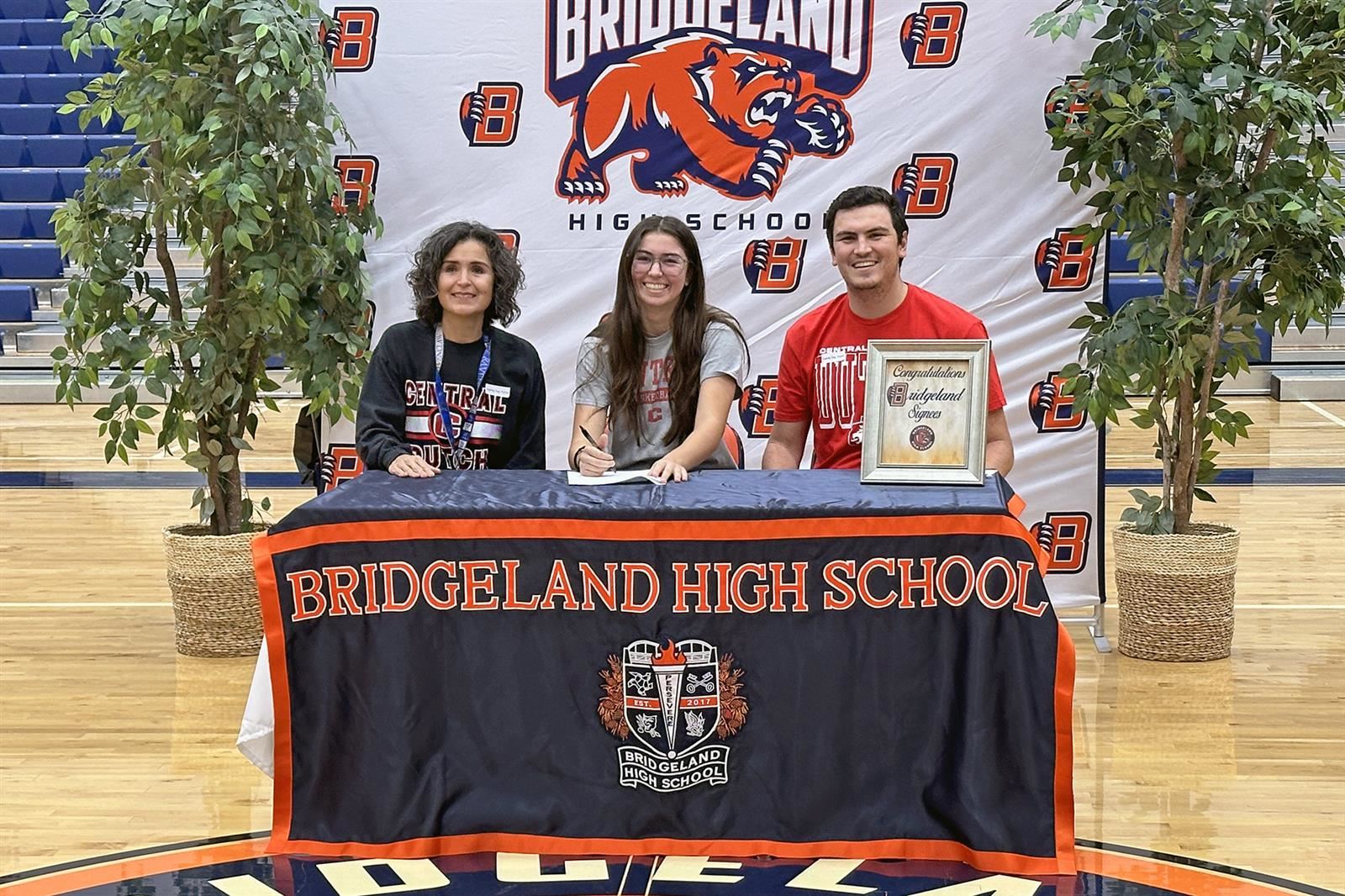 Bridgeland High School senior Jordan Penn, seated center, signed a letter of intent to play basketball at Central College.